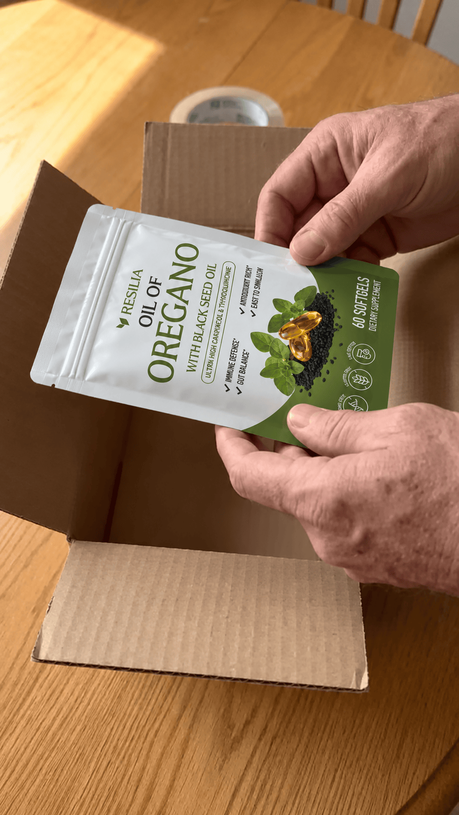 Hands placing an empty Resilia pouch into a shipping box