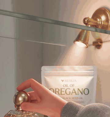 She opens the Resilia Oil of Oregano pouch and smells the softgels inside