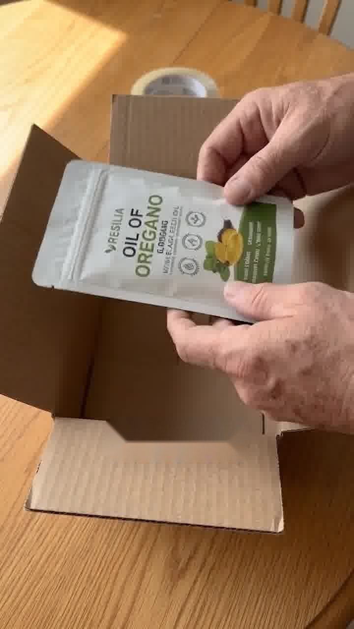 Hands placing an empty Resilia pouch into a shipping box
