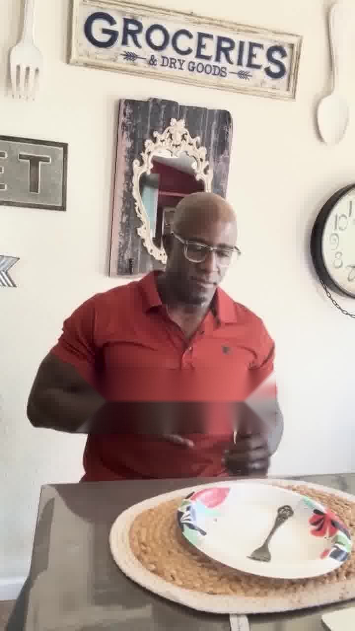 A man finishing a meal at his kitchen table