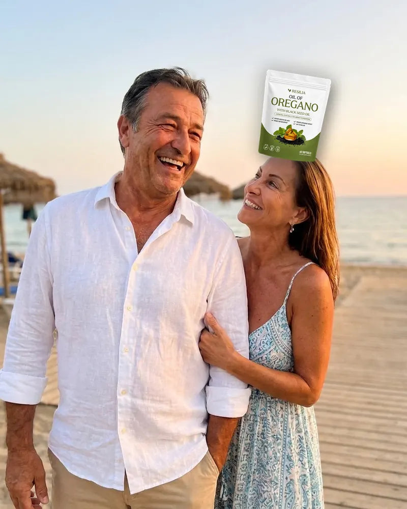 The dad laughing with his wife on the beach boardwalk at sunset