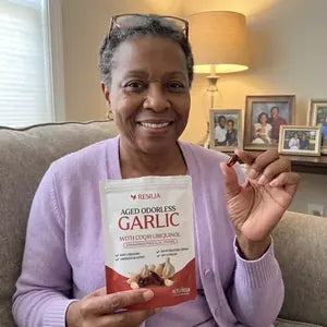 Resilia customer holding the Aged Garlic pouch